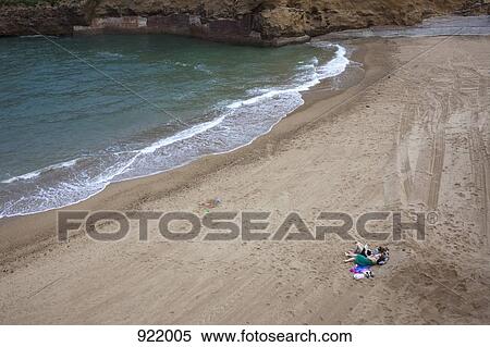 Two women lying on a beach, distant View Large Photo Image Stock Photography - Two women lying on a beach, distant. Fotosearch