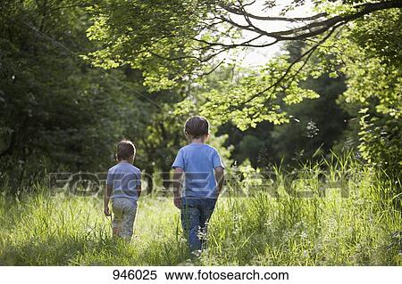 Two young boys walking outdoors in summer View Large Photo Image Stock Photography - Two young boys walking outdoors in summer. Fotosearch