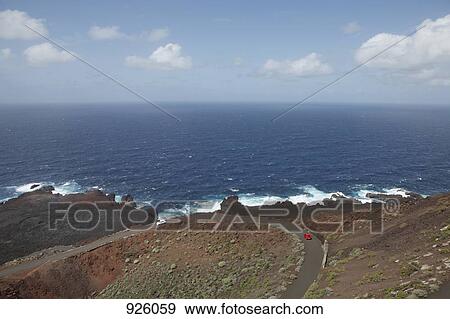 View of a car driving on a coastal road and the sea, El Hierro, Spain View Large Photo Image Stock Photo - View of a car driving on a coastal road and the sea, El Hierro, Spain. Fotosearch