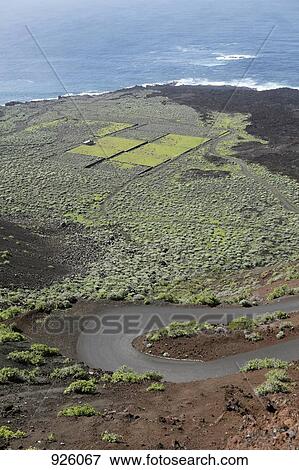 Stock Photo - View of a road and coastal landscape, El Hierro, Spain. Fotosearch
