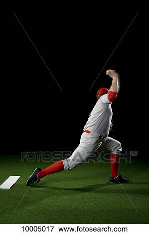Stock Photo - A baseball player after making a pitch. Fotosearch