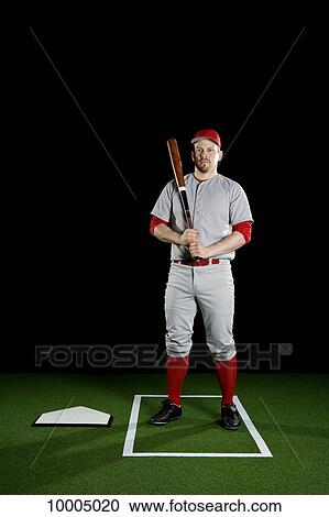 Stock Image - A baseball player, portrait, studio shot. Fotosearch
