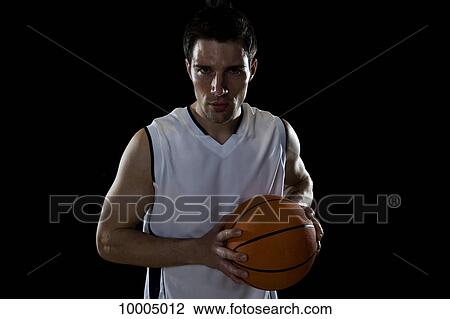 A basketball player preparing to pass a ball, portrait, studio shot View Large Photo Image Stock Image - A basketball player preparing to pass a ball, portrait, studio shot. Fotosearch