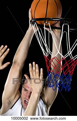 A basketball player trying to make a basket, studio shot View Large Photo Image Stock Image - A basketball player trying to make a basket, studio shot. Fotosearch