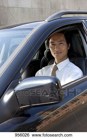 A businessman in his car, looking at camera View Large Photo Image Stock Photograph - A businessman in his car, looking at camera. Fotosearch