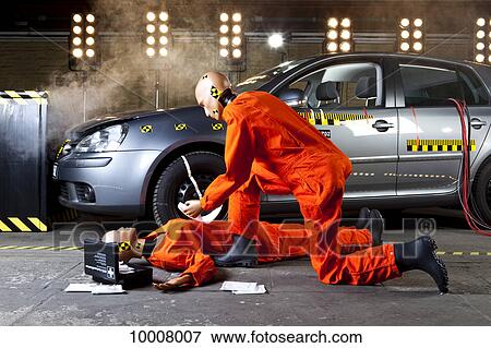 Stock Photo - A crash test dummy administering first aid on another . Fotosearch