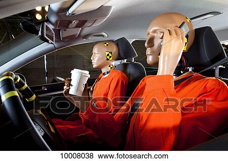 A crash test dummy carelessly using a mobile phone while driving with a crash test dummy passenger View Large Photo Image Stock Photo - A crash test dummy carelessly using a mobile phone while driving with a crash test dummy passenger. Fotosearch