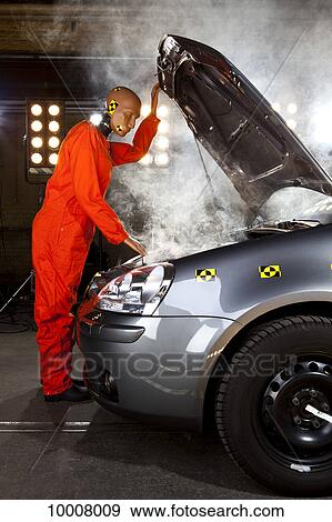 A crash test dummy checking under the hood of a smoking car View Large Photo Image Stock Photo - A crash test dummy checking under the hood of a smoking car. Fotosearch