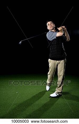 A golfer swinging a club, portrait, studio shot View Large Photo Image Stock Image - A golfer swinging a club, portrait, studio shot. Fotosearch