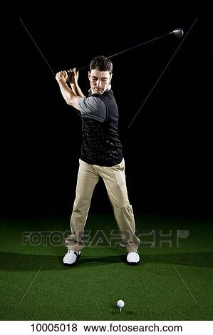 A golfer teeing off, portrait, studio shot View Large Photo Image Stock Photo - A golfer teeing off, portrait, studio shot. Fotosearch