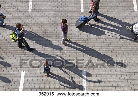 A group of people walking through a parking lot View Large Photo Image Stock Photography - A group of people walking through a parking lot. Fotosearch