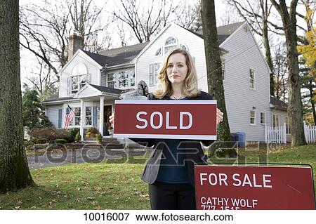 A real estate agent holding a FOR SALE sign View Large Photo Image Stock Photo - A real estate agent holding a FOR SALE sign. Fotosearch