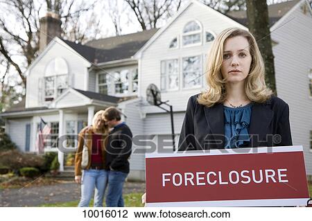 A real estate agent holding a FORECLOSURE sign View Large Photo Image Stock Image - A real estate agent holding a FORECLOSURE sign. Fotosearch