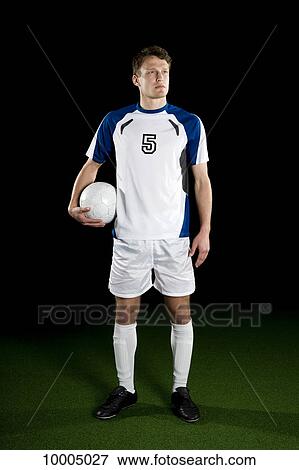 Stock Photo - A soccer player, portrait, studio shot. Fotosearch