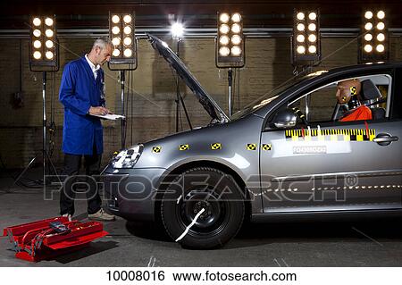 A technician checking a crash test car View Large Photo Image Stock Photograph - A technician checking a crash test car. Fotosearch
