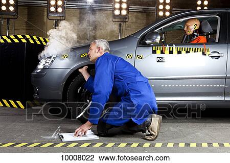 A technician examining a smoking crash test car with a crash test dummy in it View Large Photo Image Stock Image - A technician examining a smoking crash test car with a crash test dummy in it. Fotosearch