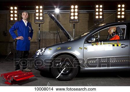 A technician standing next to a crash test car View Large Photo Image Picture - A technician standing next to a crash test car. Fotosearch