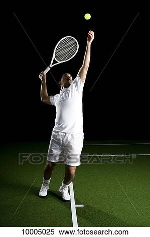 A tennis player serving a ball, portrait, studio shot View Large Photo Image Stock Photography - A tennis player serving a ball, portrait, studio shot. Fotosearch
