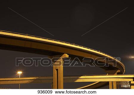 Low angle view of a highway overpass at night View Large Photo Image Stock Photo - Low angle view of a highway overpass at night. Fotosearch