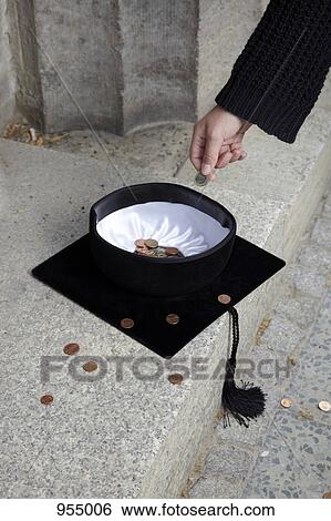 Man dropping coin into mortarboard View Large Photo Image Stock Photograph - Man dropping coin into mortarboard. Fotosearch