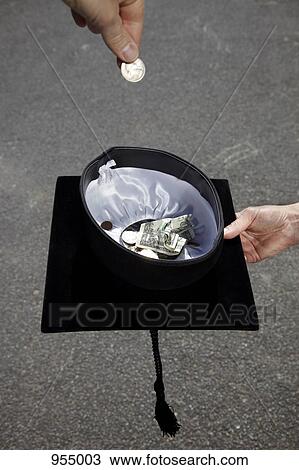 Money being put in a mortarboard View Large Photo Image Stock Image - Money being put in a mortarboard. Fotosearch