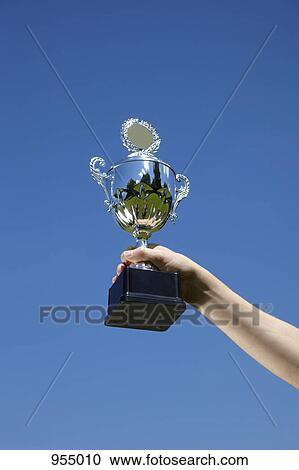 One hand raising trophy View Large Photo Image Stock Image - One hand raising trophy. Fotosearch