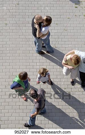 Stock Photo - People standing a plaza. Fotosearch