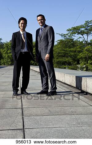 Two businessmen, outdoors, portrait View Large Photo Image Stock Image - Two businessmen, outdoors, portrait. Fotosearch