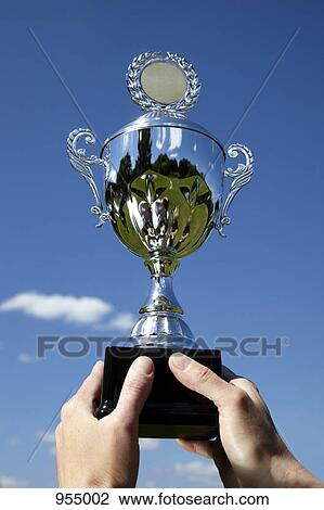 Two hands raising trophy View Large Photo Image Stock Image - Two hands raising trophy. Fotosearch