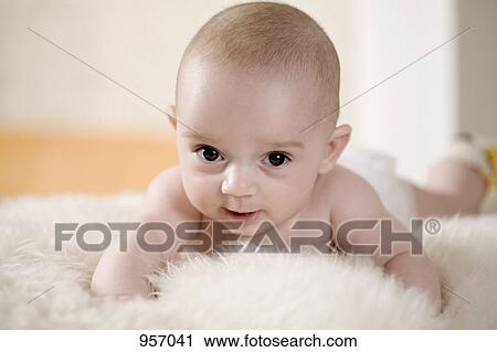 A baby lying on a shag rug, looking at camera View Large Photo Image Stock Image - A baby lying on a shag rug, looking at camera. Fotosearch