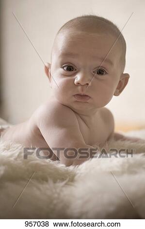 A baby lying on a shag rug View Large Photo Image Stock Photo - A baby lying on a shag rug. Fotosearch
