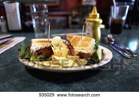 A BLT with ruffled potato chips View Large Photo Image Stock Photo - A BLT with ruffled potato chips. Fotosearch