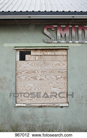 A boarded up window of a run down building View Large Photo Image Stock Image - A boarded up window of a run down building. Fotosearch