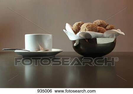 A bowl of donut holes and a cup of coffee View Large Photo Image Stock Photograph - A bowl of donut holes and a cup of coffee. Fotosearch
