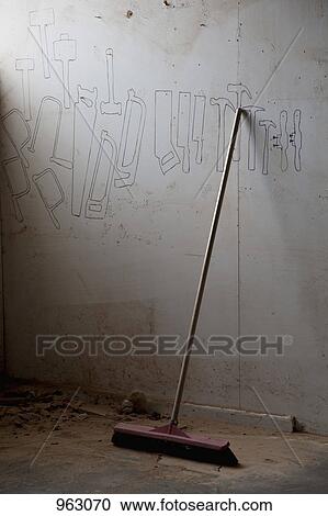 A broom leaning against a wall in a workshop View Large Photo Image Stock Image - A broom leaning against a wall in a workshop. Fotosearch