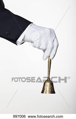 A butler ringing a hand bell for service, focus on hand View Large Photo Image Stock Photograph - A butler ringing a hand bell for service, focus on hand. Fotosearch