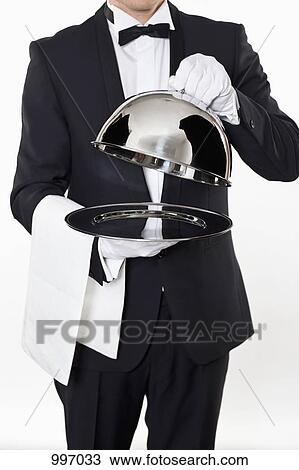 A butler taking the domed lid off an empty silver tray View Large Photo Image Stock Image - A butler taking the domed lid off an empty silver tray. Fotosearch
