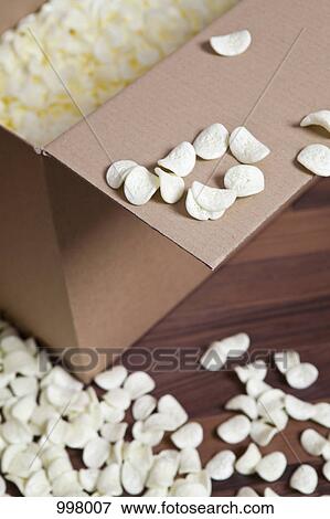 Stock Photo - A cardboard box and packing peanuts. Fotosearch