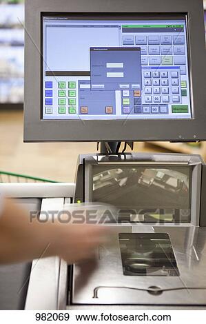 A cashier scanning groceries at a supermarket, focus on hand View Large Photo Image Stock Photo - A cashier scanning groceries at a supermarket, focus on hand. Fotosearch