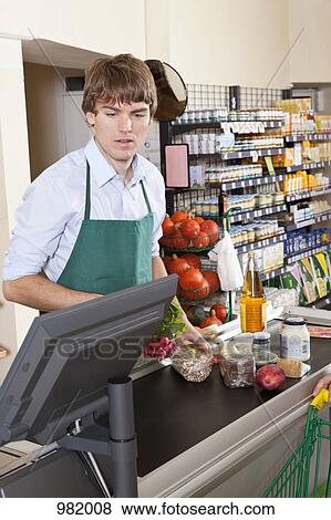 A cashier working in a supermarket View Large Photo Image Stock Photo - A cashier working in a supermarket. Fotosearch