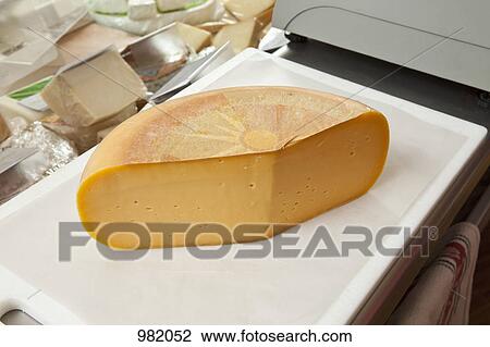 A cheddar cheese wheel View Large Photo Image Stock Image - A cheddar cheese wheel. Fotosearch