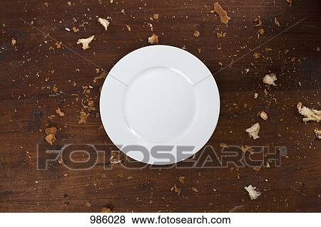 A clean plate on a table with crumbs View Large Photo Image Stock Photo - A clean plate on a table with crumbs. Fotosearch