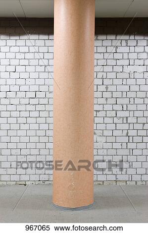 Stock Photography - A column in front of a white brick wall. Fotosearch
