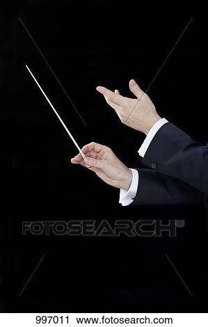 Stock Image - A conductor conducting, focus on hands. Fotosearch