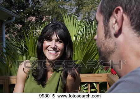 A couple chatting on a backyard deck View Large Photo Image Stock Photography - A couple chatting on a backyard deck. Fotosearch