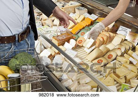A customer and clerk in a wine and cheese shop View Large Photo Image Stock Photo - A customer and clerk in a wine and cheese shop. Fotosearch