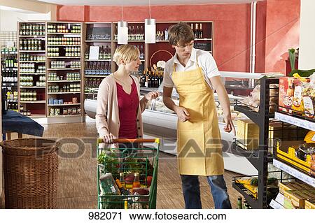 A customer and grocer in a supermarket View Large Photo Image Stock Image - A customer and grocer in a supermarket. Fotosearch
