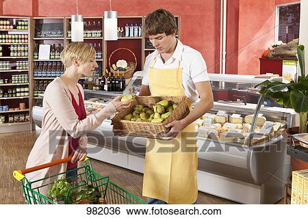 A customer and grocer in a supermarket View Large Photo Image Stock Photograph - A customer and grocer in a supermarket. Fotosearch