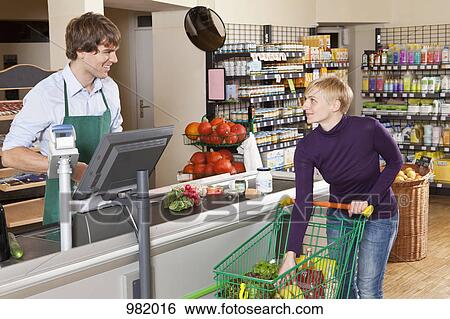 A customer checking out in a supermarket View Large Photo Image Stock Photograph - A customer checking out in a supermarket. Fotosearch