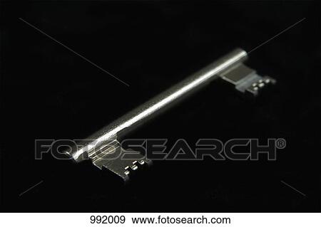 A double-ended key, black background View Large Photo Image Stock Photo - A double-ended key, black background. Fotosearch